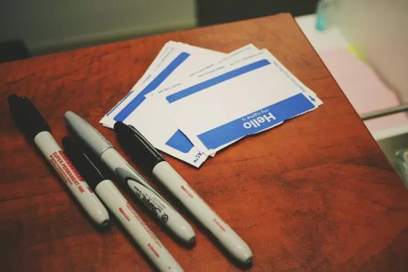 Image of sharpie pens and name tags; Photo by Jon Tyson on Unsplash