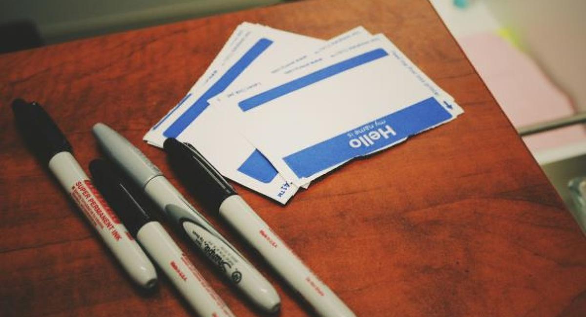 Image of sharpie pens and name tags; Photo by Jon Tyson on Unsplash